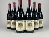 six bouteilles de vin rouge alignées
