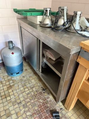 an image of a kitchen with a lot of clutter on the floor