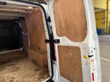 a white van with a wooden door open in a building