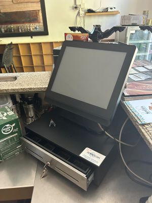 an image of a cash register machine with a box of beer