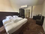an image of a bedroom with a bed and a dresser