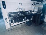 a kitchen with a sink and a refrigerator in it