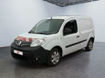 La petite camionnette blanche est garée dans une grande pièce.