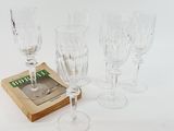 four wine glasses and a book on the table