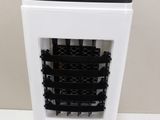 a black and white air purifier sitting on a table