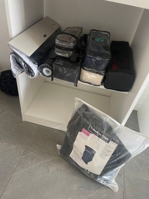 many bags of luggage sitting on a shelf in a room