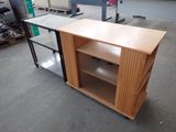 a desk with a book shelf in the middle of the room