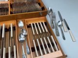 many spoons, forks and spoons in a wooden box