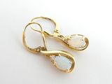 pair of oplite and diamond earrings on a white surface