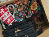 a box full of purses that are sitting on the floor