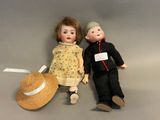 two dolls sitting next to each other on a table