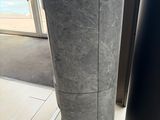 two black trash cans sitting on the floor next to each other