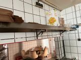 a small kitchen with a stove and a table and chairs