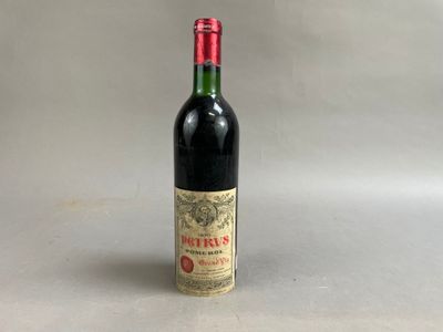 an old bottle of wine sitting on top of a table