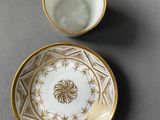 a close up of a cup and saucer on a table