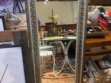 a large mirror that is sitting on a table in a room