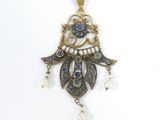 an image of a close up of a pendant on a white surface