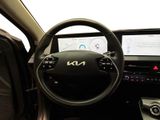 a steering wheel and dashboard of a car with a display on it