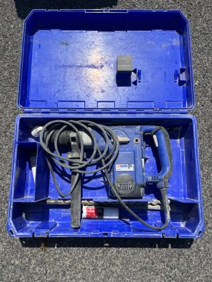 a blue box with a drill and a cord in it