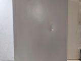 a white refrigerator sitting on a counter in a kitchen