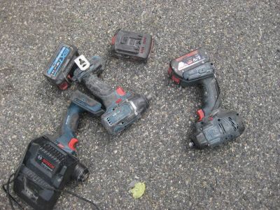 four tools laying on the ground next to each other