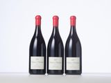 three bottles of wine sitting on top of a table
