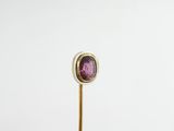 pink tourmaline gems in a gold ring on a stick