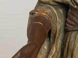 statue of a woman holding a glass of wine in her hand