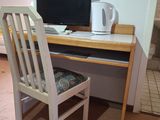 a desk with a chair and a computer on it