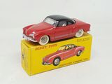 a red toy car sitting on top of a yellow box