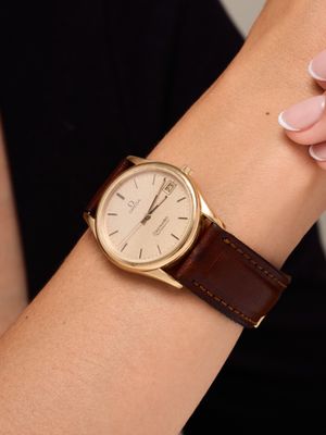 a woman that is holding a watch on her wrist