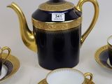 a black and gold tea set on a white table