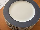 a stack of plates sitting on a table with a price tag on it