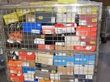 a metal cart with many boxes on it in a warehouse