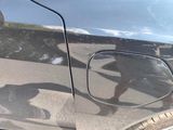 a reflection of a person on the side of a car door