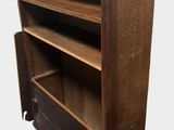an old wooden bookcase with two open shelves on top of it
