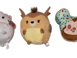 three stuffed animals sitting next to each other on a white surface