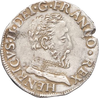 Gros plan sur une pièce d'argent portant le visage d'un homme