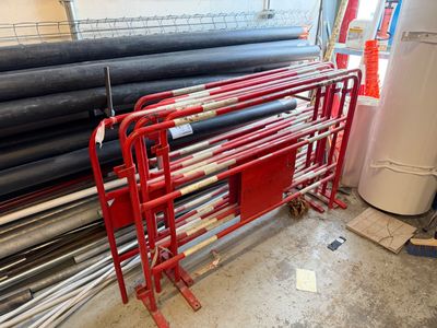 many rolls of pipe on a rack in a warehouse