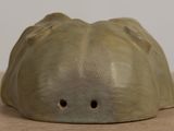 a clay sculpture of a face on a table