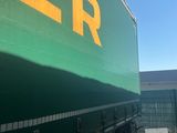 a green truck that is parked in a parking lot