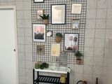 a picture of a room with a fire extinguisher and pictures on the wall