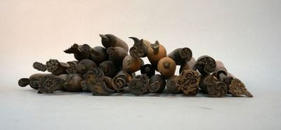 a pile of carved animal heads on a white surface