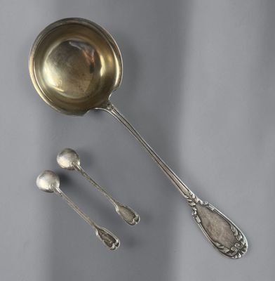 two spoons and a spoon rest on a table