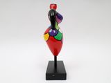 a colorful sculpture of a woman on a black base
