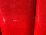 a close up of a red chair with a red seat