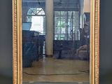 a mirror that is sitting on a table in front of a wall