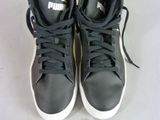a pair of black and white sneakers on a white surface