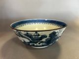 a blue and white bowl sitting on a table