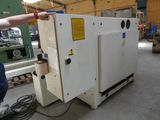 a man standing next to a machine in a factory